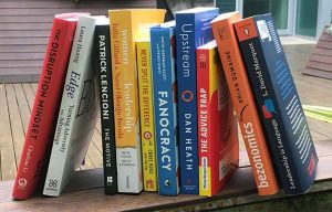 Shelf with business books leaning against each other