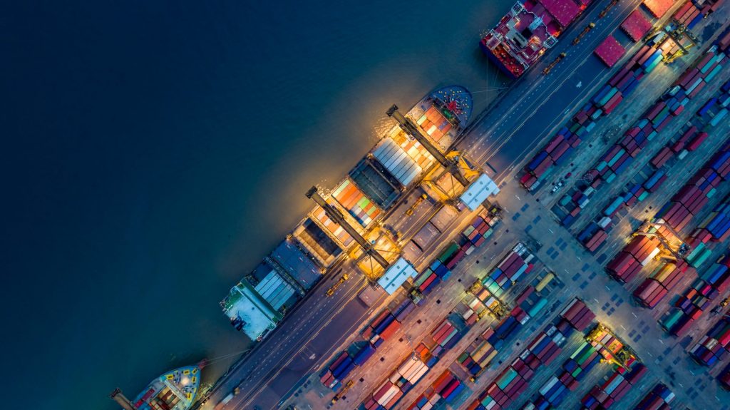 Colorful cargo containers at night.